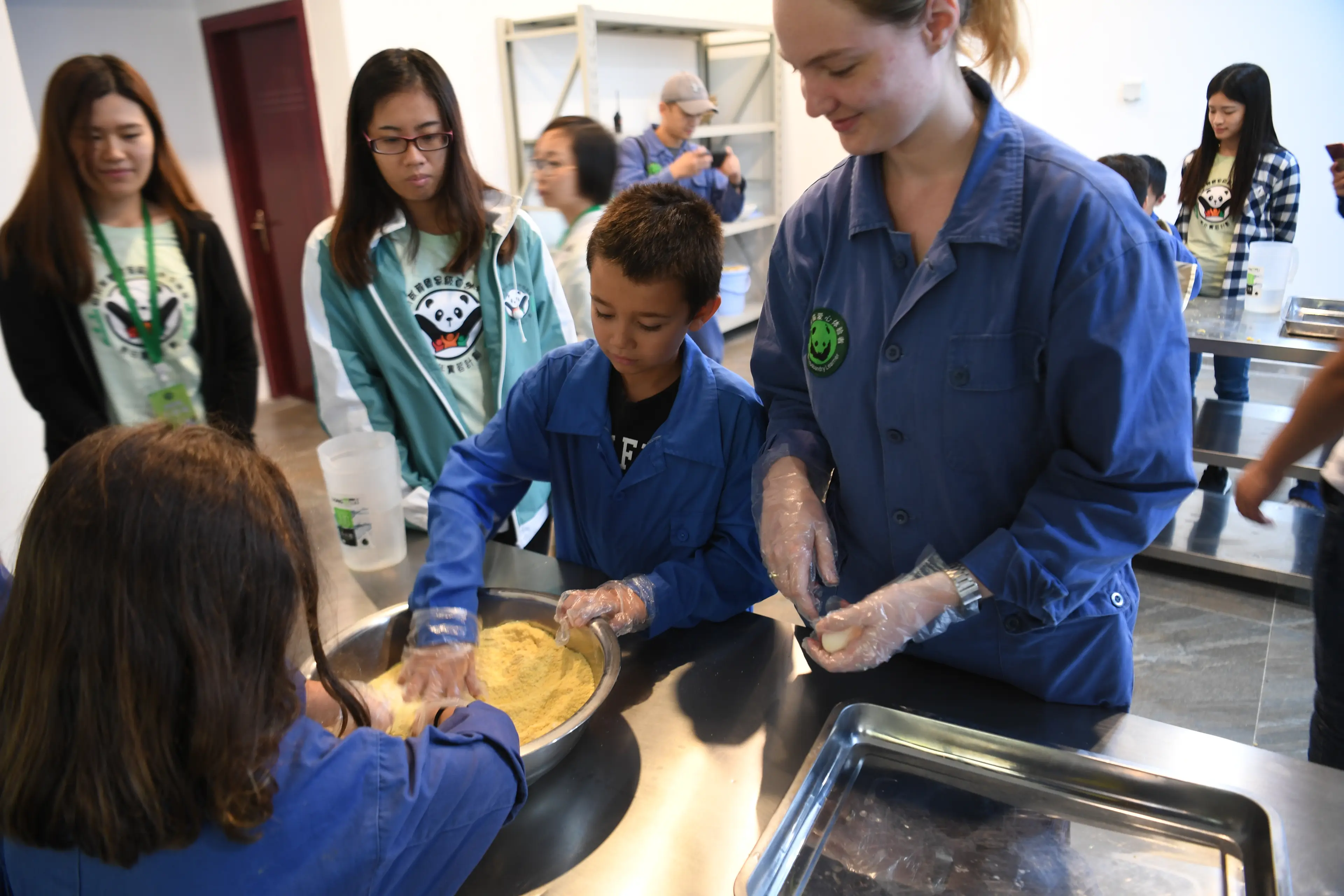 Volunteer panda cake workshop at Wolong, family